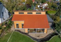 Komplettaufnahme von Einfamilienhaus mit Dachziegel J160 in altrot mit Kurzrost auf Pultdach