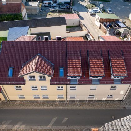Vogelperspektive von Mehrfamilienhaus mit Tonziegel J11v in der Edelengobe edelkupfer
