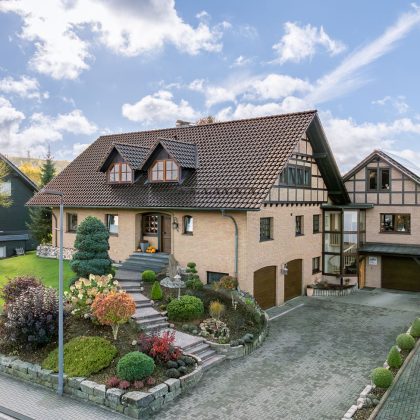 Jacobi Referenzobjekt mit Dachziegel J11v in edelbraun auf verklinkertem, saniertem Einfamilienhaus mitten im Grünen mit Vorgarten und Hofeinblick