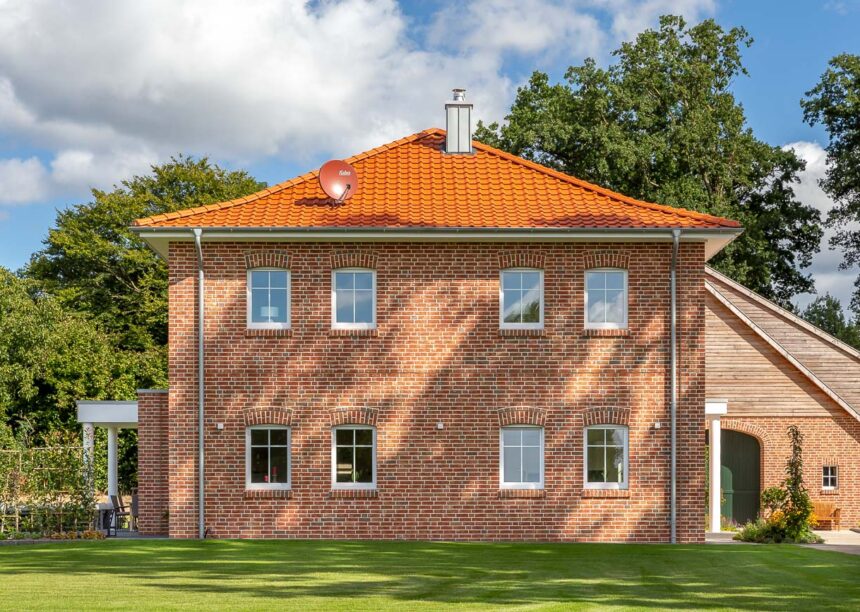 Anmutige Klinkervilla mit Flachdachziegel und Schmuckfirst mit harmonischer Farbabstimmung von Dach und Klinker.