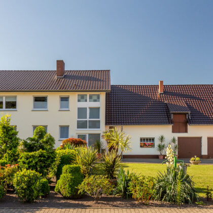 Edelbraune Dachfläche auf 70/8er Jahre Bau und gepflegtem Vorgarten.