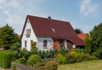 Satteldach von saniertem Einfamilienhaus mit Dachziegel J11v in edelweinrot in der Gesamtansicht