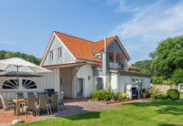 Einfamilienhaus mit Holzelementen und Flachdachziegel J13v in altrot auf dem Dach