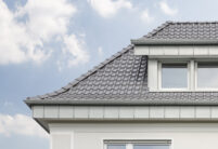 Wohnhaus mit Anbau und Flachdachziegel J13v in silbergrau auf dem Dach