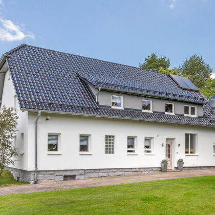 Einfamilienhaus mit Krüppelwalmdach, Flachdachziegel J13v in schiefergrau matt
