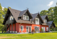 Farbenfrohes Einfamilienhaus mit vielen Satteldachgauben und Reformziegel Z10 im trendigen altschwarz mit Terrasseneinblick