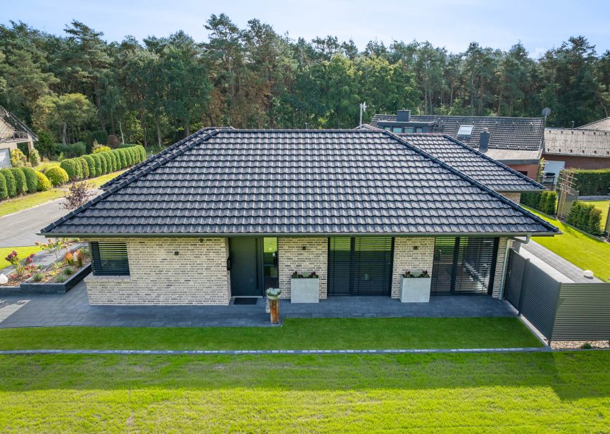 Großfalzziegel Z10 in edelschwarz auf Klinkerbungalow, Firstziegel F6v, und 3achsige Walmkappe in der gesamten Ansicht von der Nordseite fotografiert