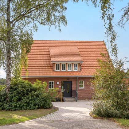 Aus der Frontalansicht fotografiert: Jugendtreff mit Dachziegel Doppelmulde Z2 in naturrot, verklinkerte Fassade mit Satteldach