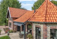 Traumhaftes Klinker-Holz-Haus mit Turm und Hohlfalzziegel Z5 in friesisch-bunt Salzbrand von Jacobi Dachziegel mit Terrasseneinblick